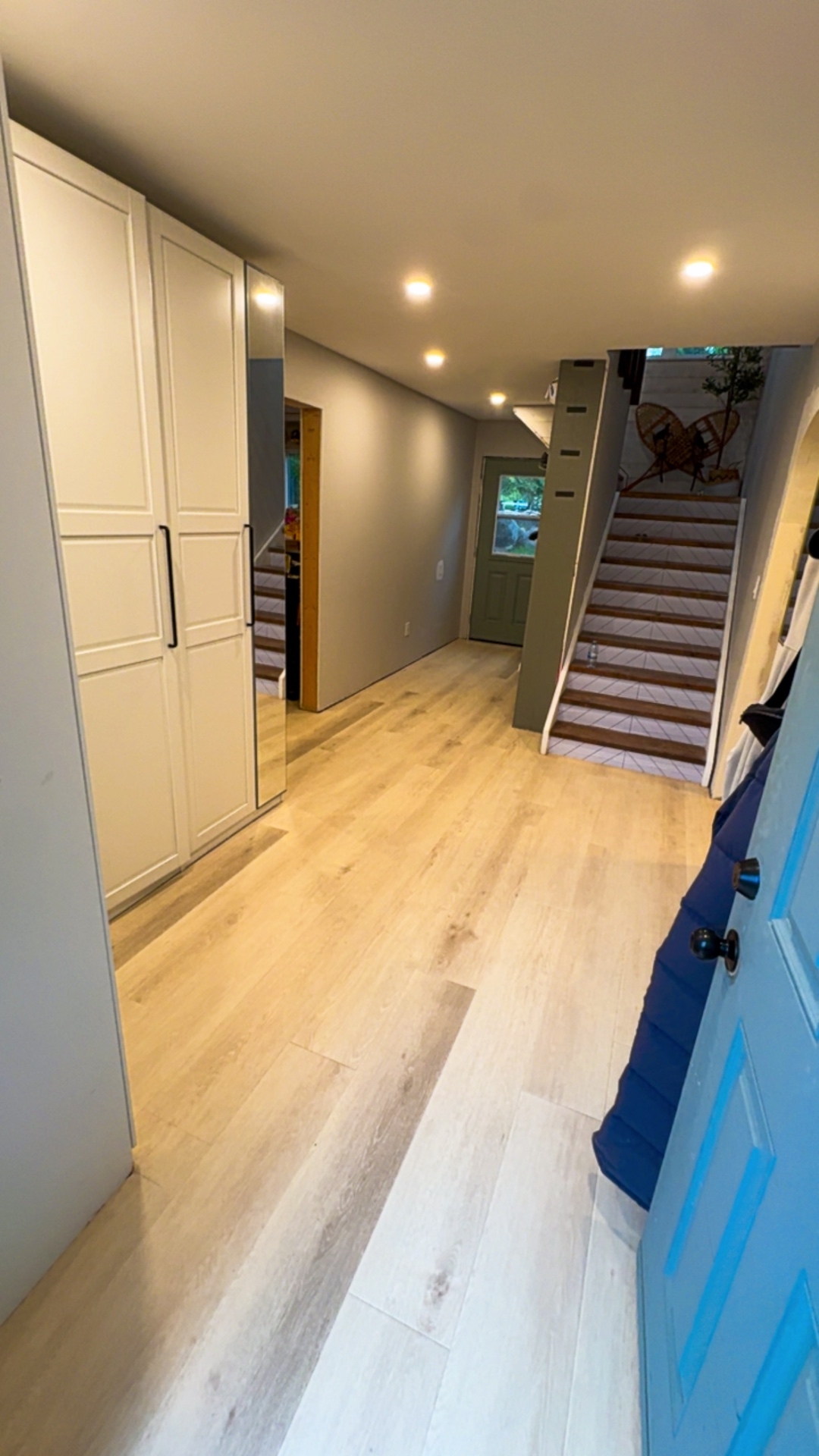 Newly installed luxury vinyl plank flooring in a bright entryway